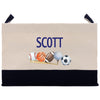 A beige canvas bag with a black trim, featuring a personalized name "SCOTT" printed on it. The bag also displays various sports balls, including a baseball, a basketball, and a soccer ball, arranged on a baseball bat.