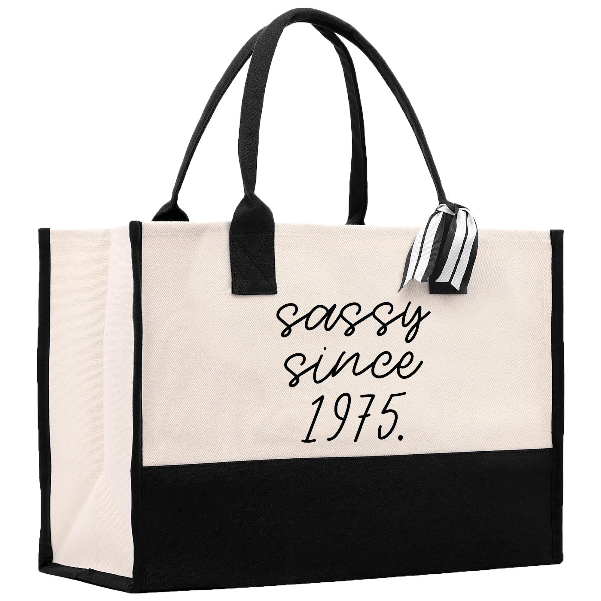 a black and white shopping bag with the words sassy since 1971 printed on it