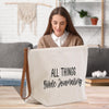 a woman sitting at a table with a bag on it
