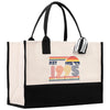 A beige tote bag with a black handle and straps, featuring a graphic design on the front that says 