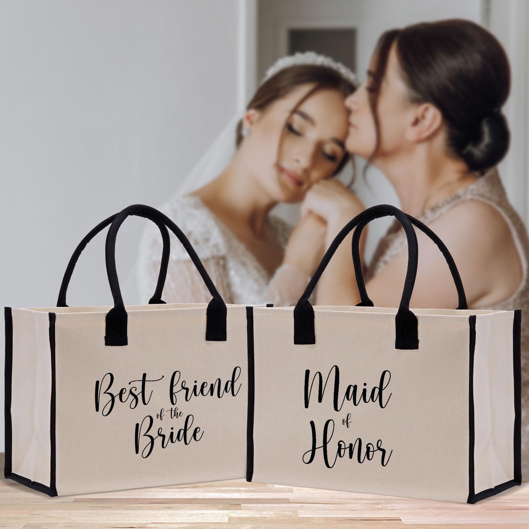 a bride and groom kissing in front of two bags