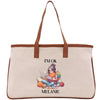 a canvas tote bag with a picture of a woman reading a book