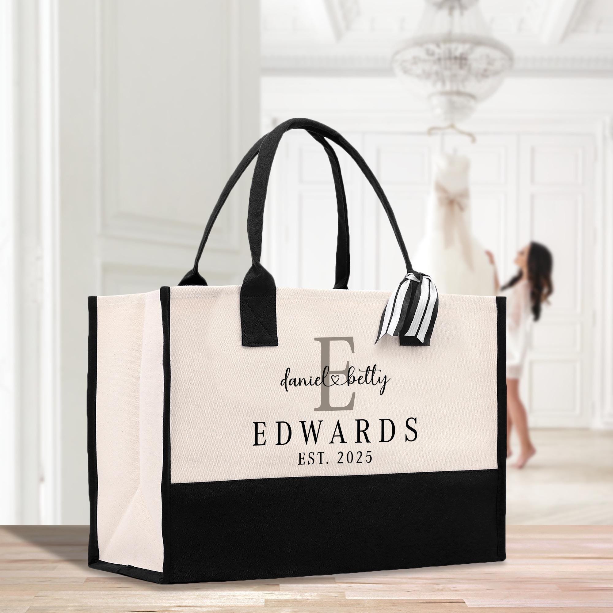a black and white bag with a monogrammed logo