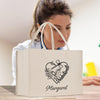 a woman holding a shopping bag that says margaret