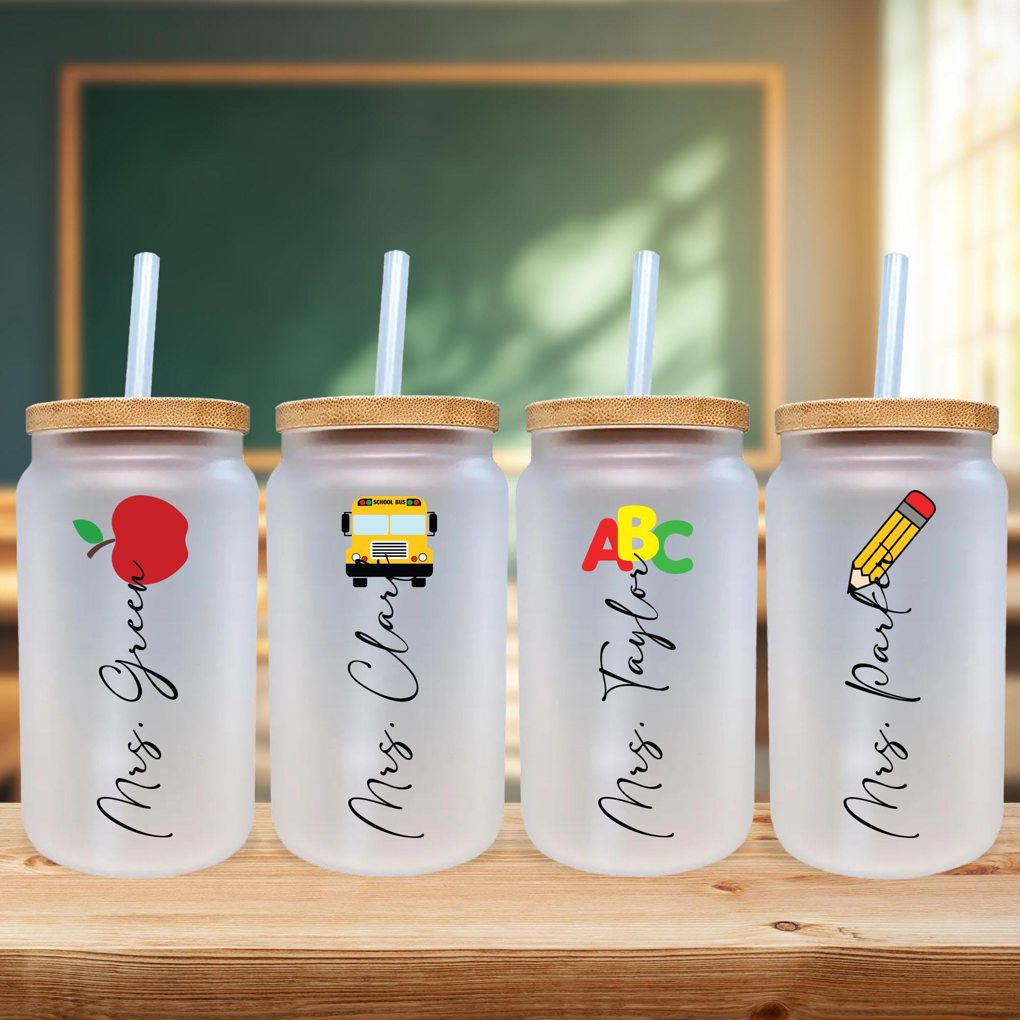 a row of three personalized plastic cups with straws