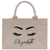 a white bag with eyelashes and eyelashes on it