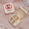a white box with a ring and a ring box with a picture of a cow