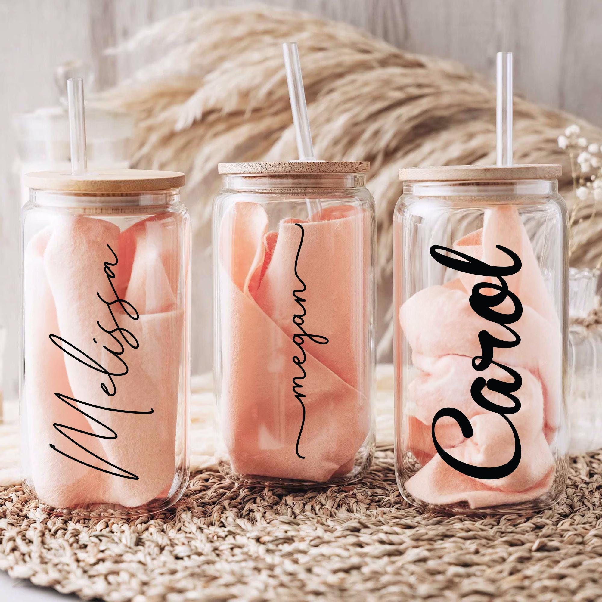 three mason jars filled with candy and a straw