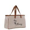 A beige canvas tote bag with a brown handle and a floral design printed on it.