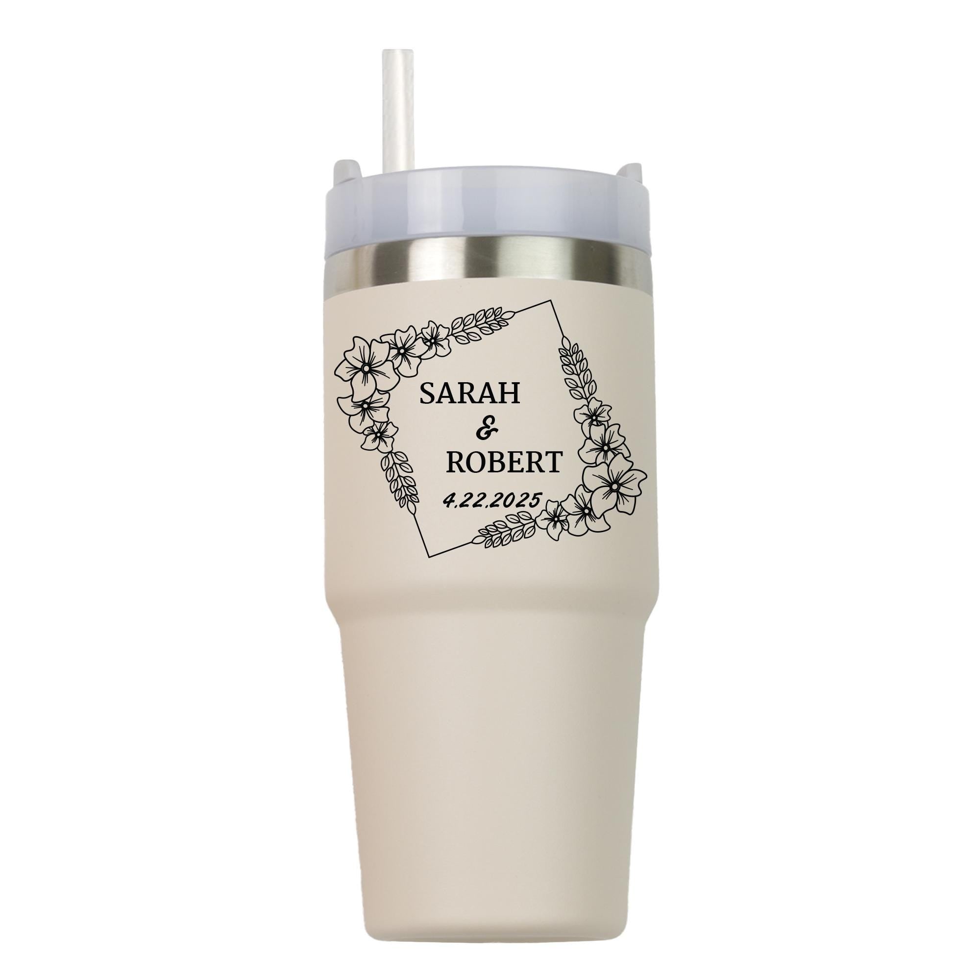 A beige insulated tumbler with a floral design and text printed on it.