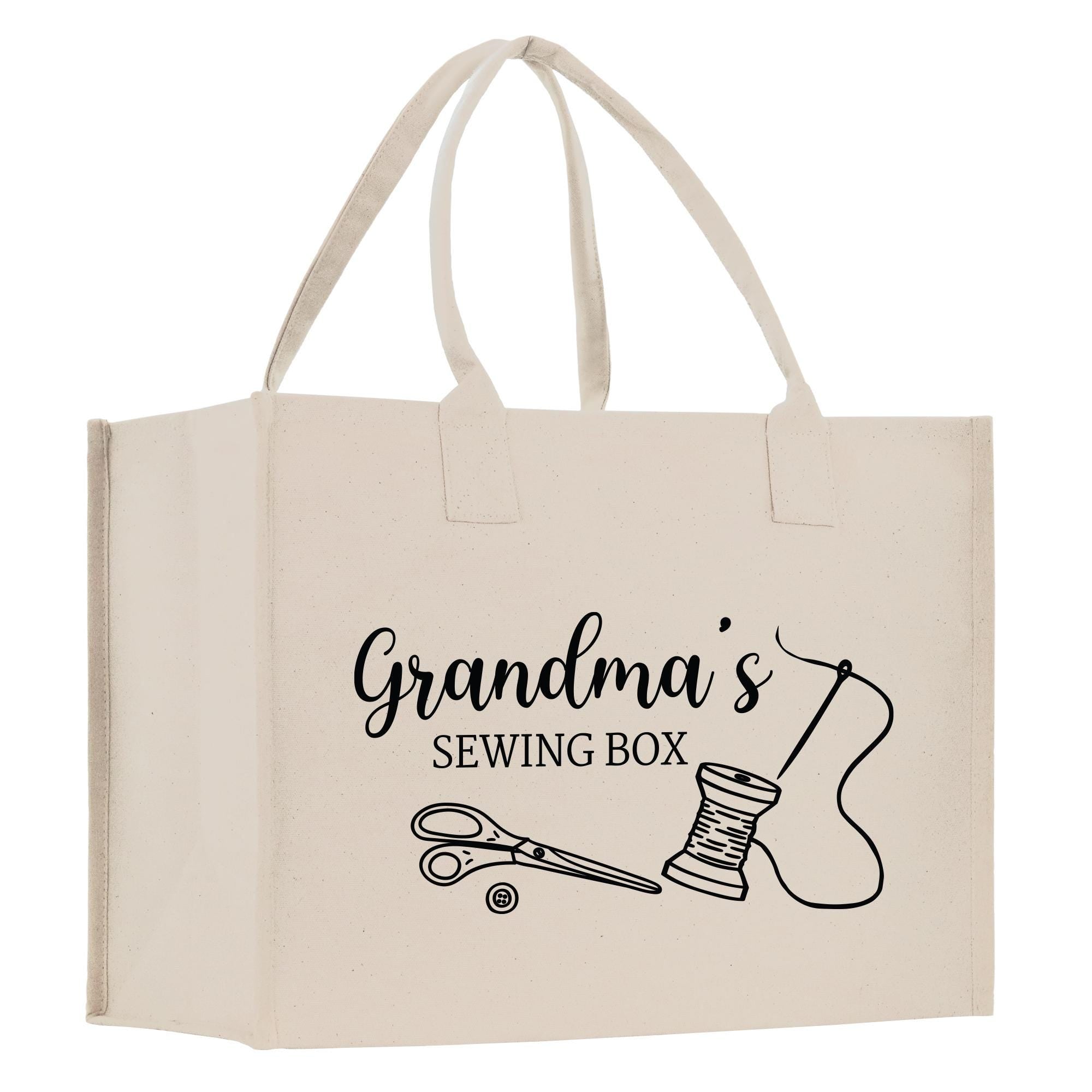 A beige canvas tote bag with the text &quot;Grandma&#39;s Sewing Box&quot; printed on it, along with illustrations of sewing-related items such as scissors and a spool of thread.
