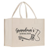 A beige canvas tote bag with the text "Grandma's Sewing Box" printed on it, along with illustrations of sewing-related items such as scissors and a spool of thread.