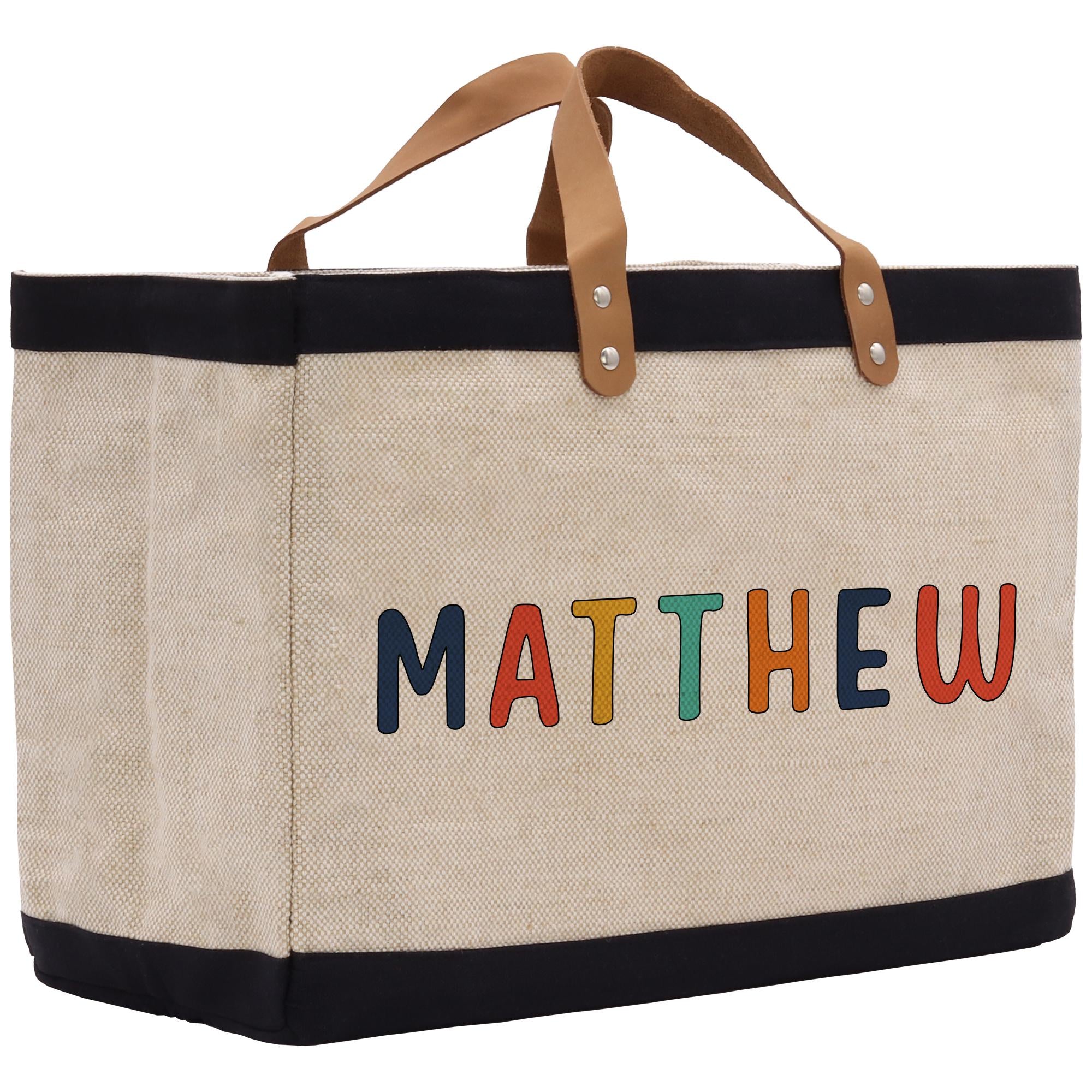 a canvas bag with the word mathew painted on it