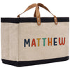 a canvas bag with the word mathew painted on it