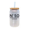 A frosted glass jar with a straw, featuring the text "N°50 Rebecca Smith London" printed on it.