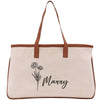 A beige canvas tote bag with a brown leather strap and a floral design printed on it.