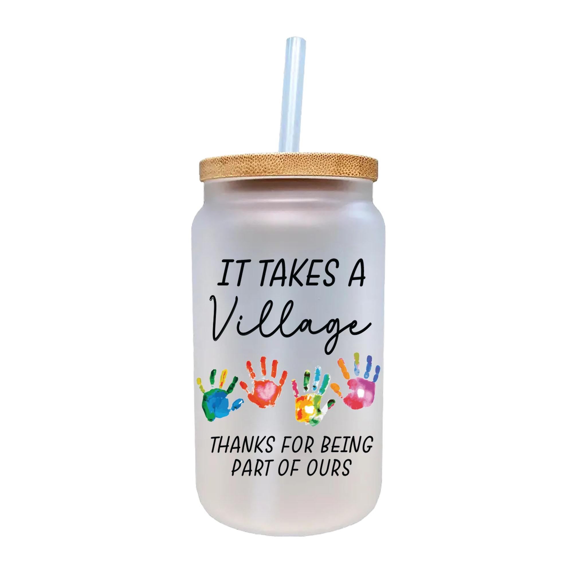 a glass with a straw in it that says it takes a village thanks for being