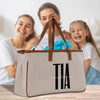a woman and two girls are holding a bag