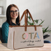 a woman sitting at a table with a bag