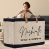 A large tote bag with the text "Nashville" printed on it, along with the coordinates "36.1627 N, 86.716 W".