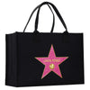 A black tote bag with a pink star-shaped logo featuring the name 'Linda Perez' on it.