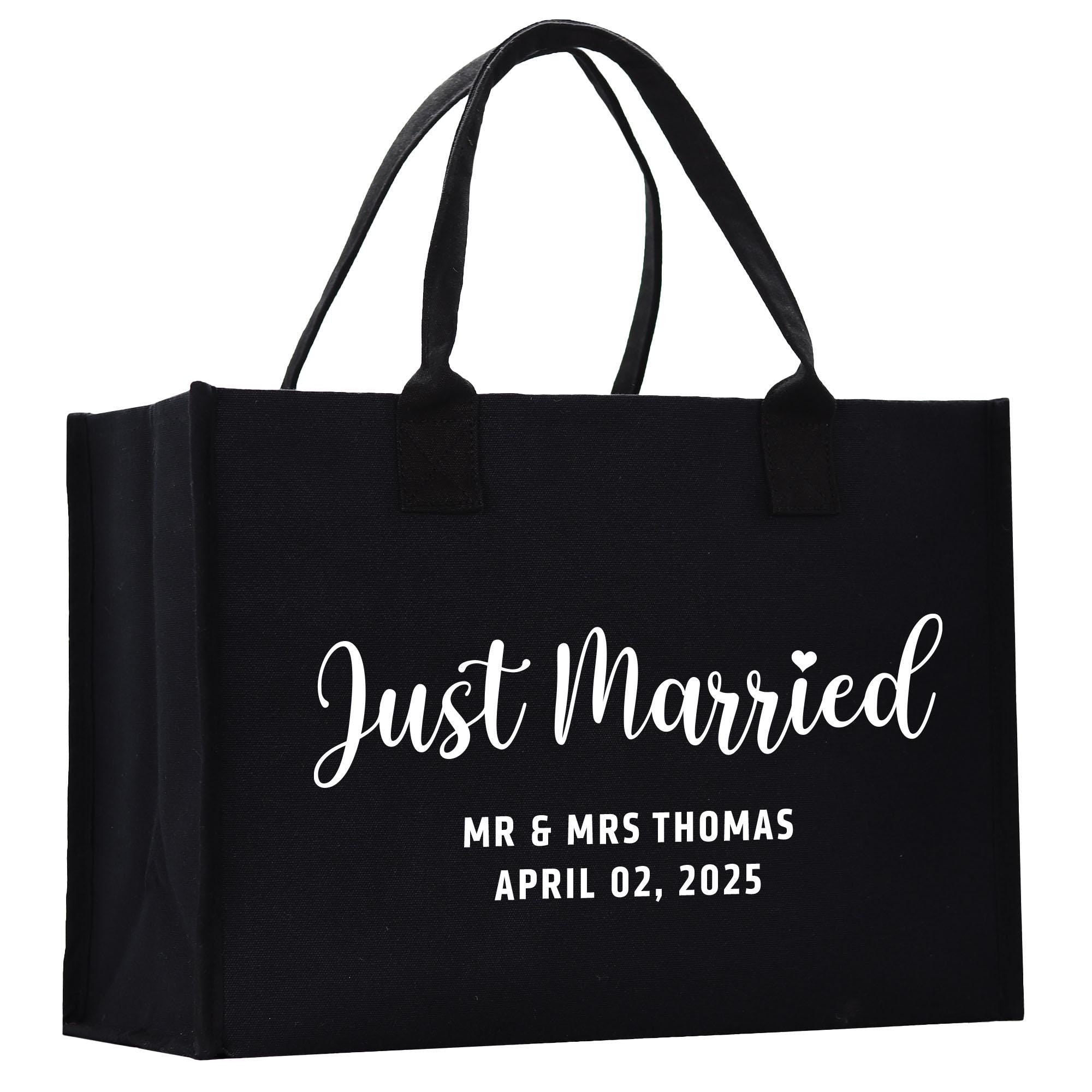 a black shopping bag with the words just married printed on it
