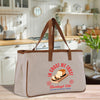 A beige tote bag with a graphic design of bread and the text "In the trust" printed on it, placed on a kitchen counter.