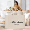 a woman sitting on a couch with a bag in front of her