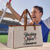 a man holding a baseball bat and a tote bag