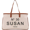 A beige tote bag with brown straps and the text "N° 30 SUSAN TEXAS" printed on it.