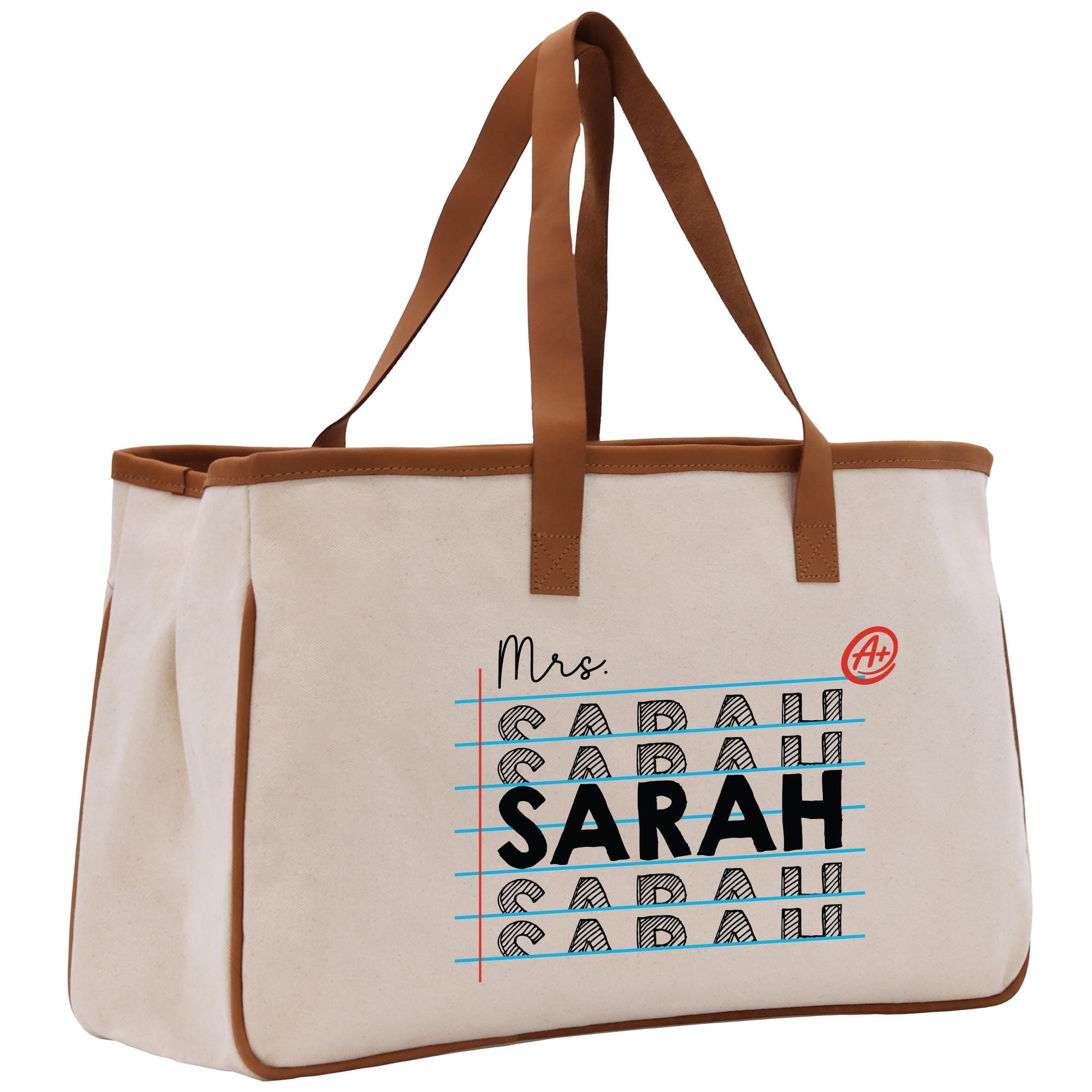 a canvas tote bag with a leather handle