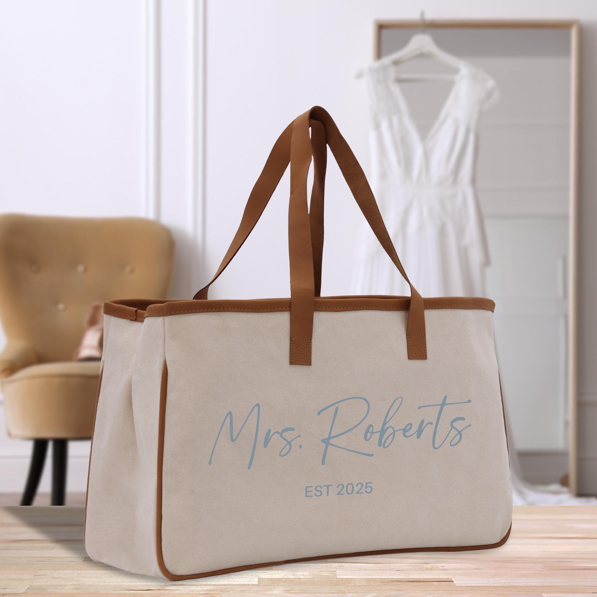 a canvas tote bag with a leather handle