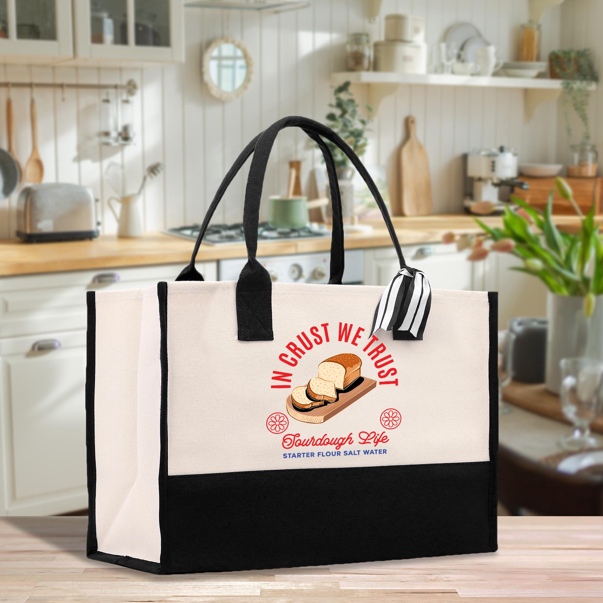 A tote bag with a graphic design featuring bread and salt, placed on a kitchen counter.