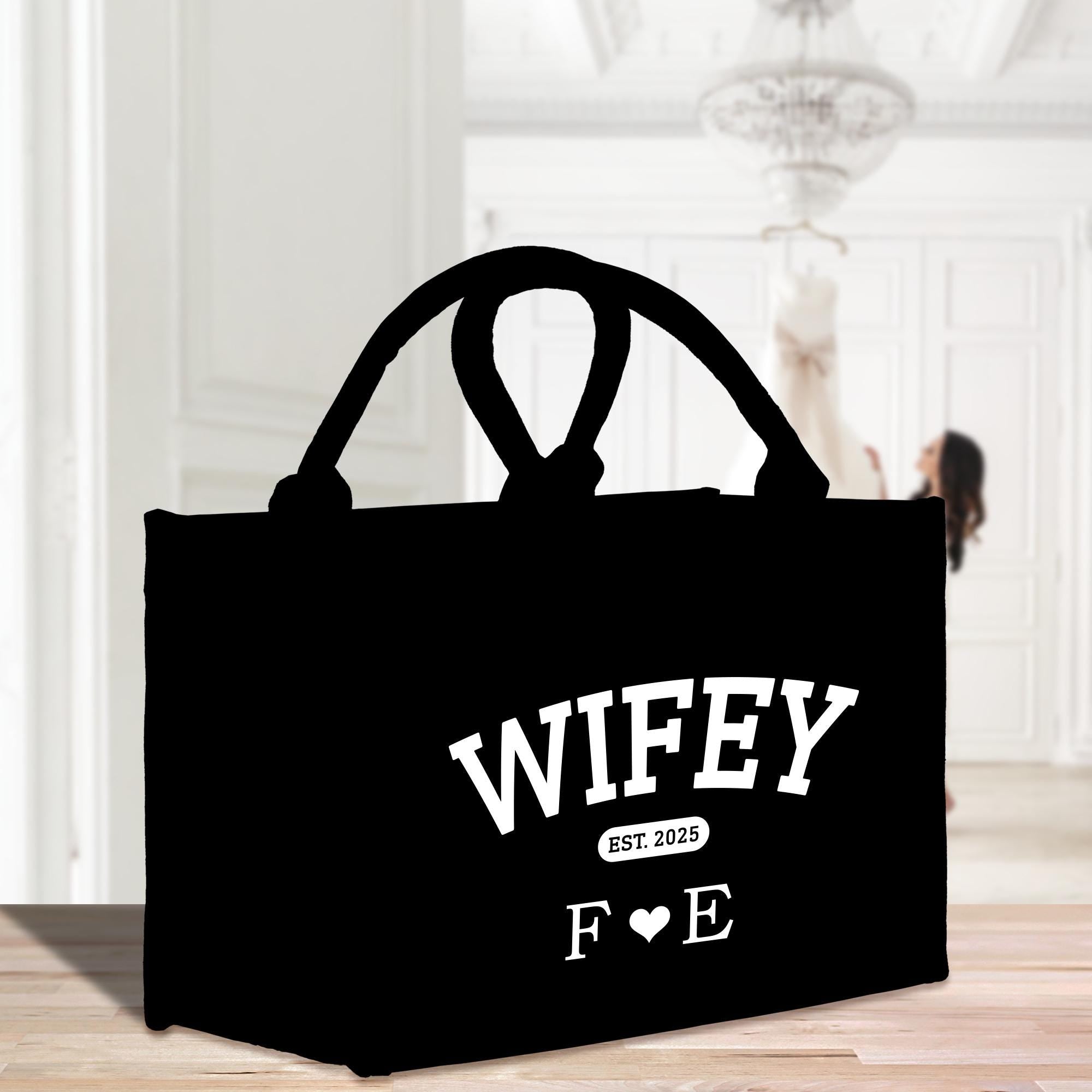 a black shopping bag with the words wife on it