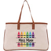 A beige canvas tote bag with a brown handle and a colorful crayon design printed on it.