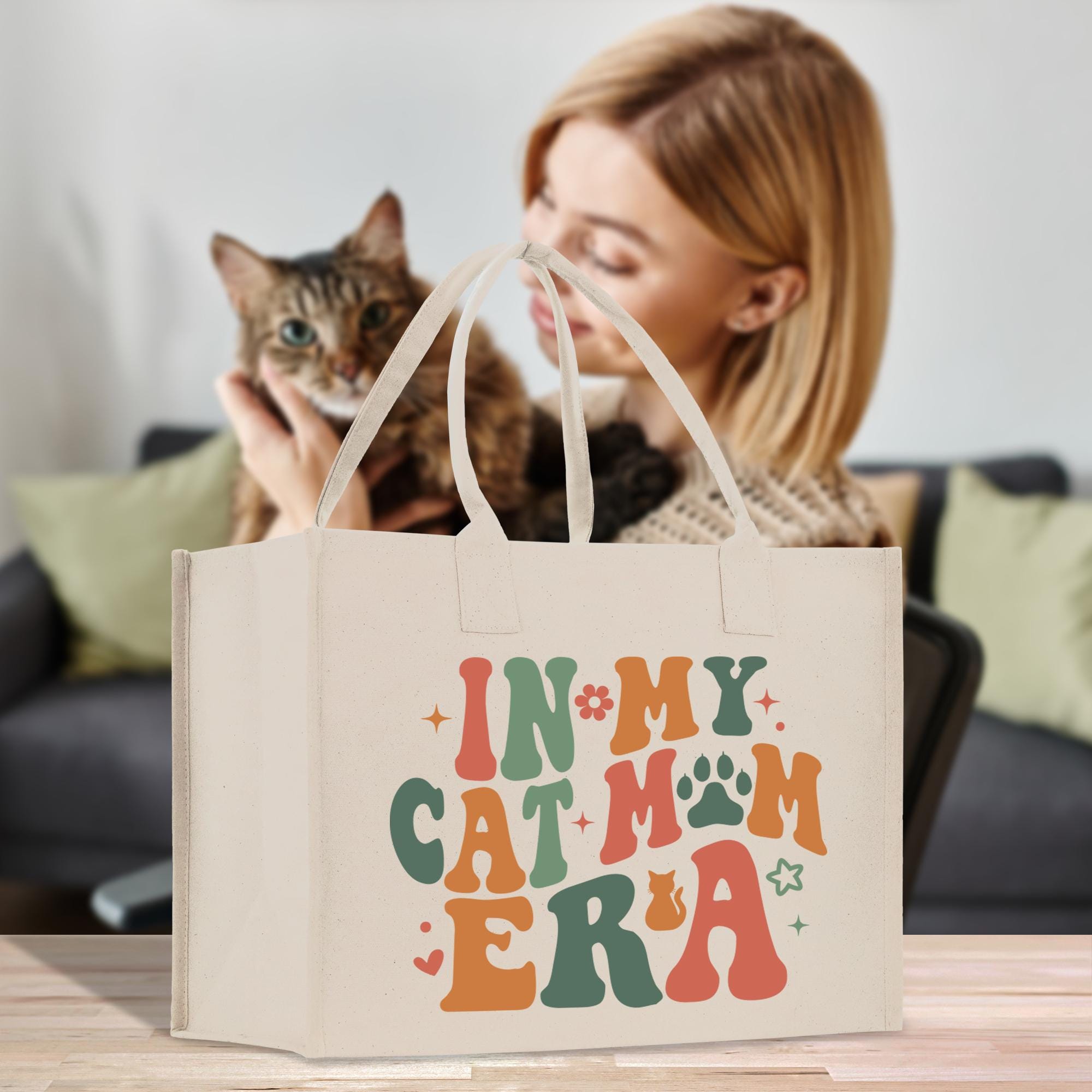 a woman holding a cat in a bag