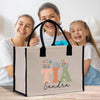 a woman and two girls are holding a shopping bag