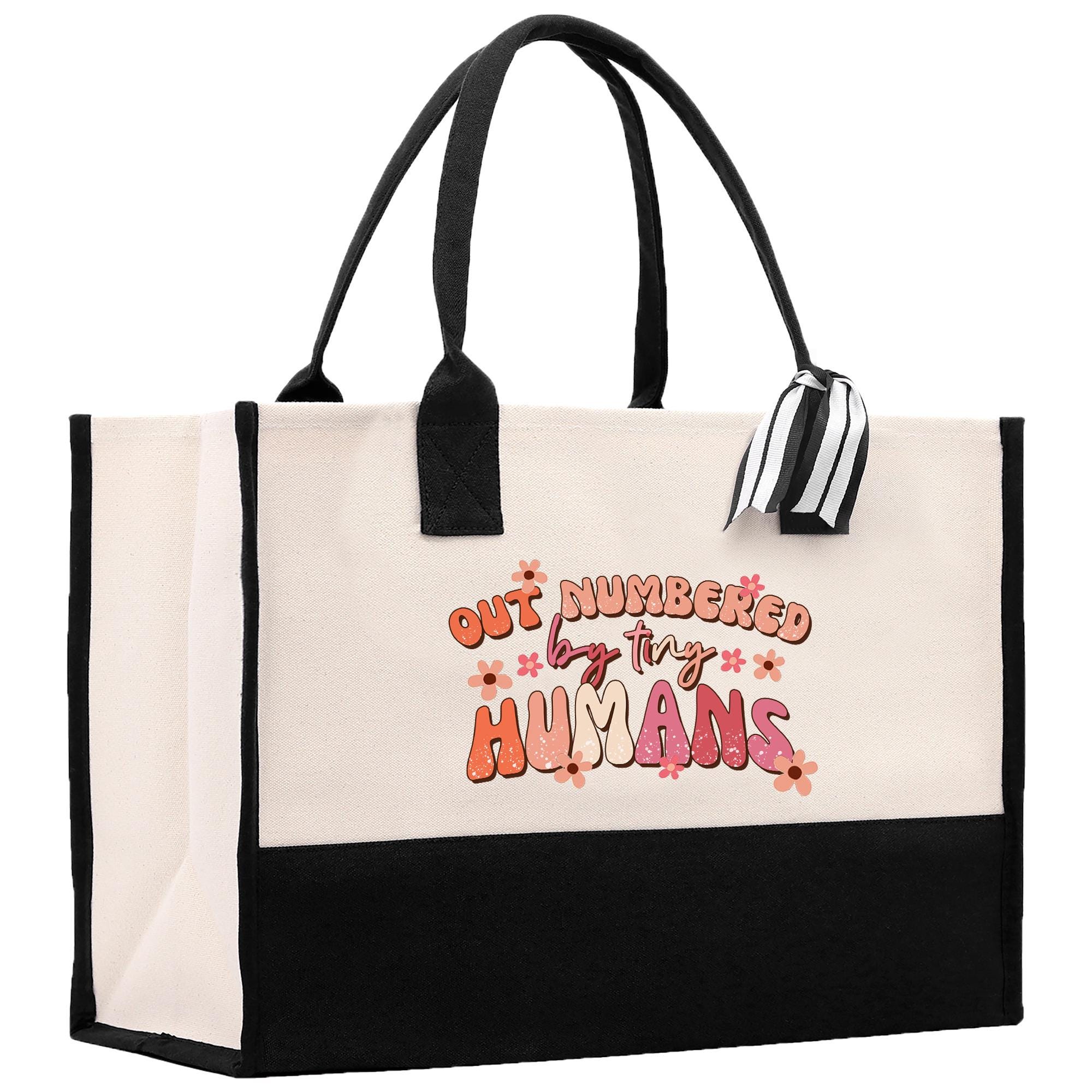a black and white tote bag with embroidered words