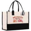a black and white tote bag with embroidered words