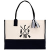 A black and white tote bag with a monogrammed logo on the front.