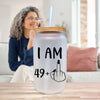 a woman sitting at a table with a glass
