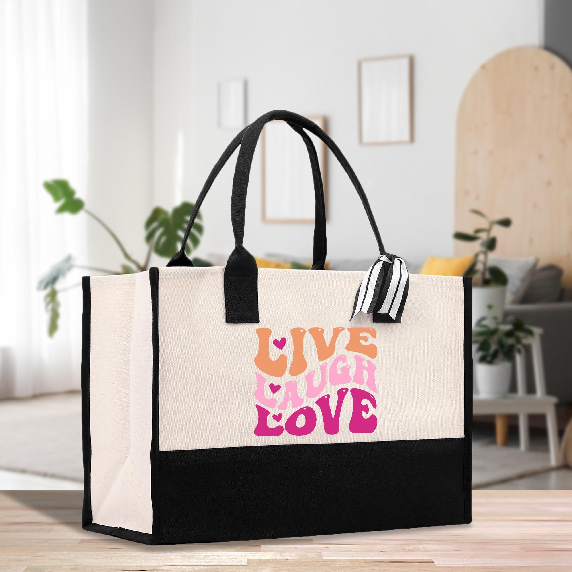 a black and white shopping bag with a live laugh love design