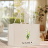 a white shopping bag with a flower on it