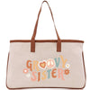 A beige tote bag with the text "GROOVY SISTER" printed on it.