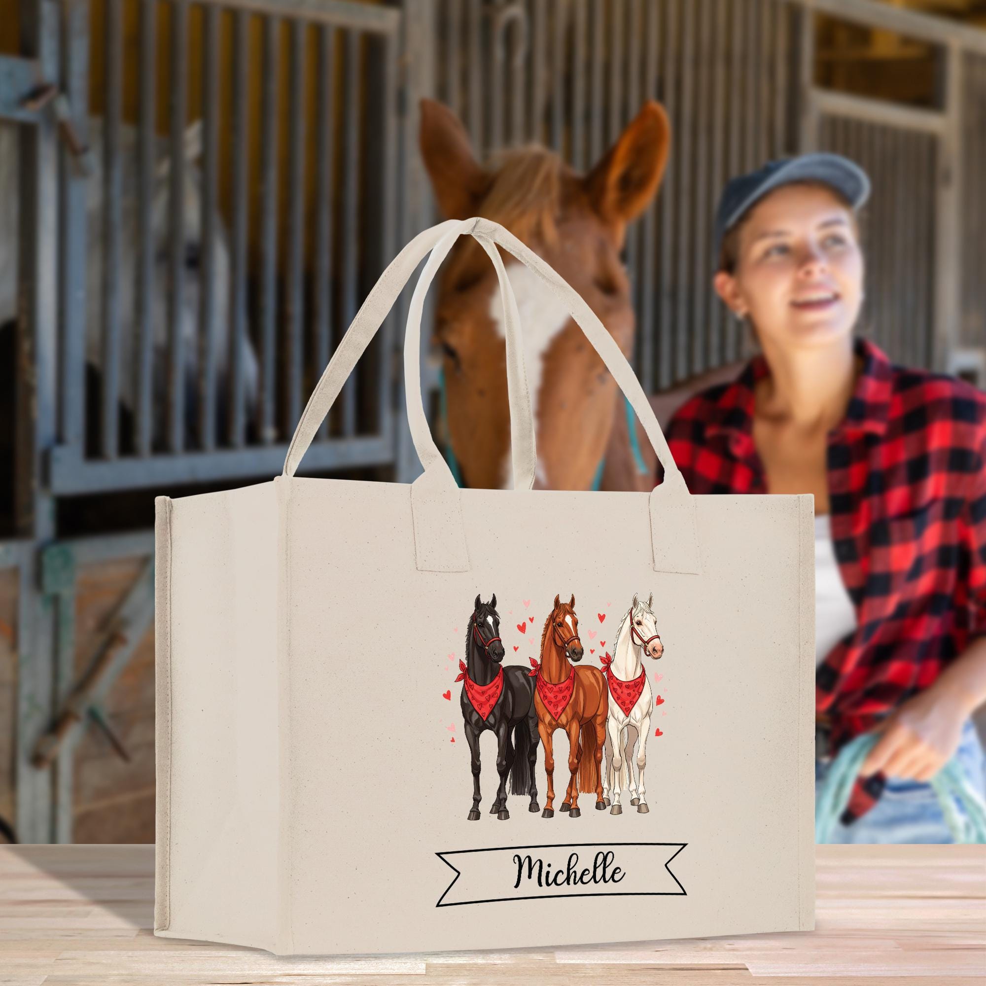 a woman sitting in front of a bag with horses on it