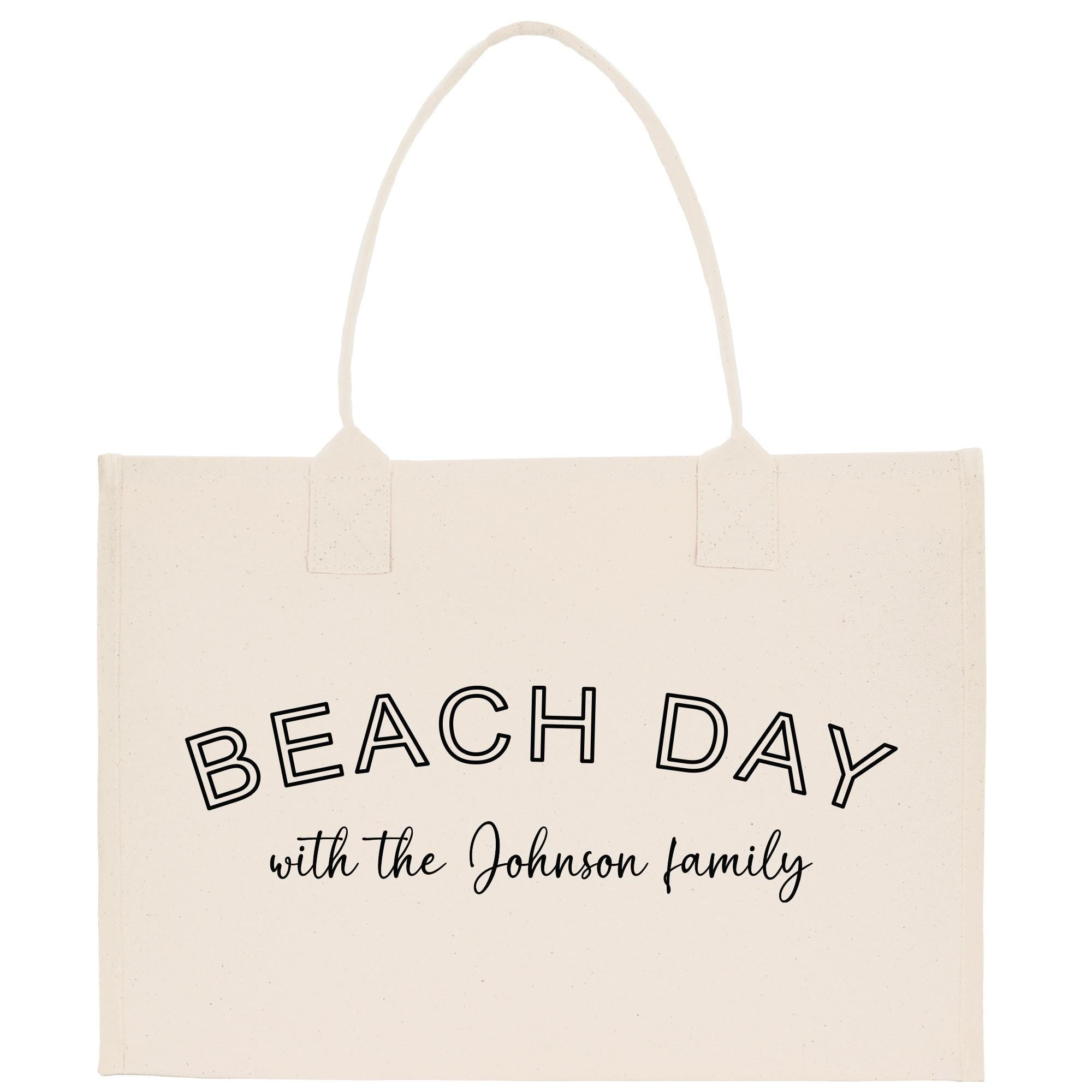 a white beach bag with the words beach day with the johnson family