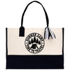 A tote bag with a black and white design featuring a camping scene and the text 