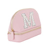A pink makeup bag with a zipper closure and a large letter "M" made of rhinestones or pearls on the front.