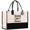 a black and white tote bag with hockey mom on it