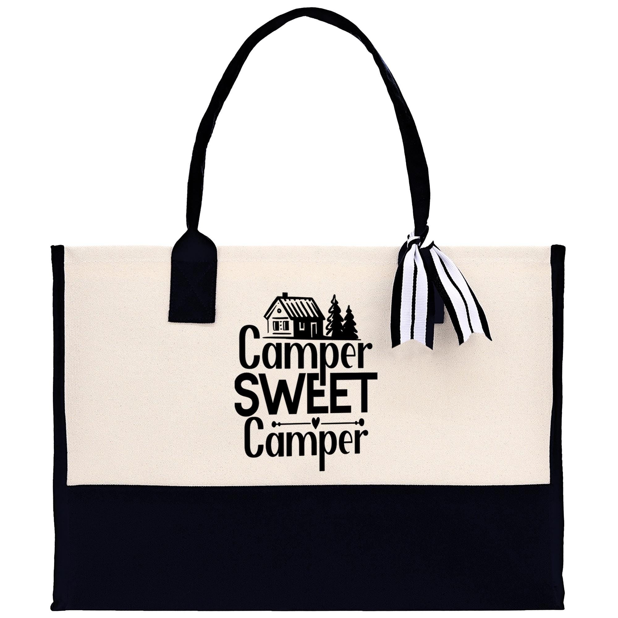 A black and white tote bag with the text "Camper Sweet Camper" printed on it.